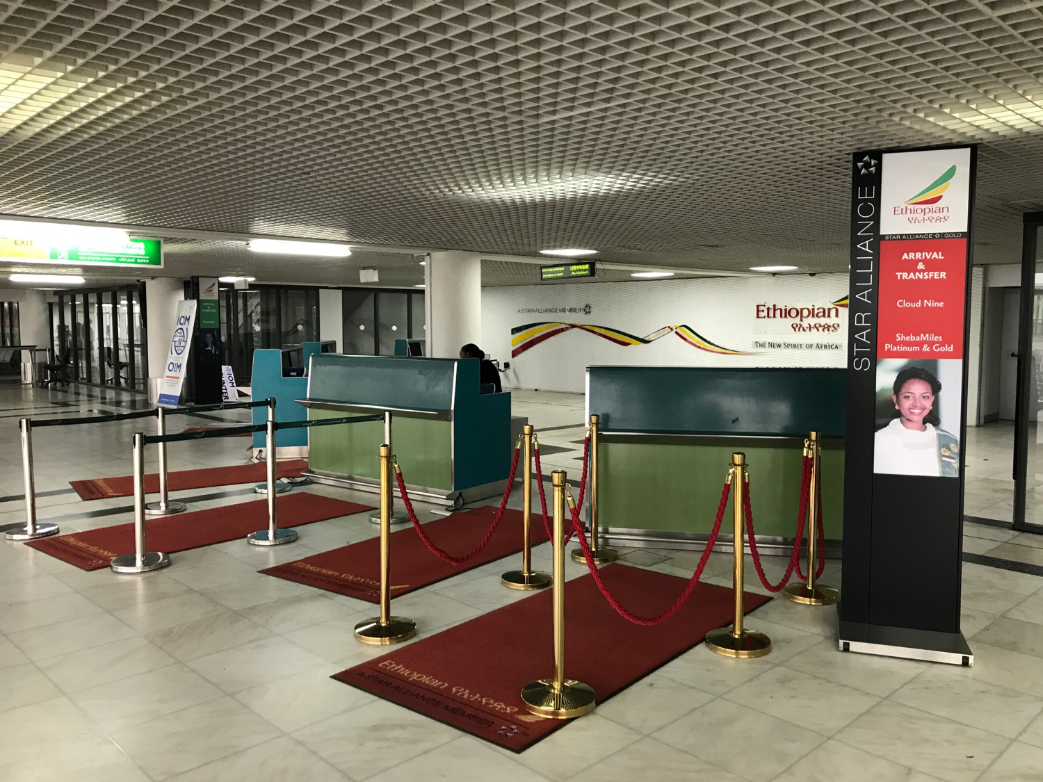 a red carpeted area with a sign and a poster