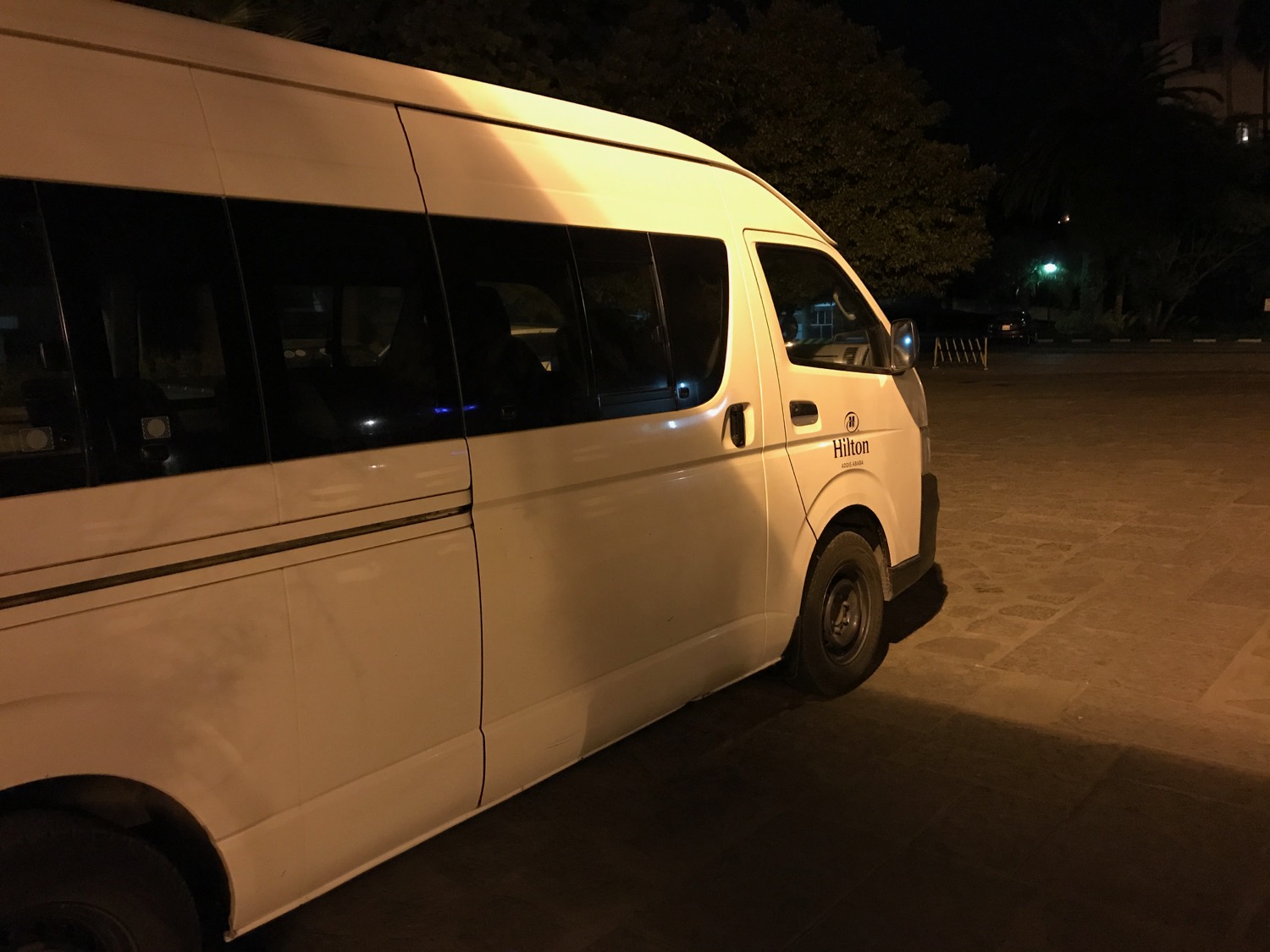 a white van parked on a street at night