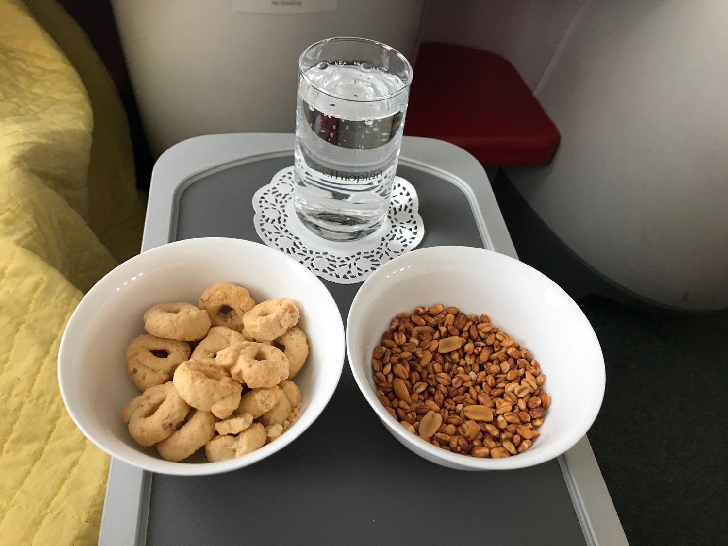 a bowl of cereal and nuts on a tray