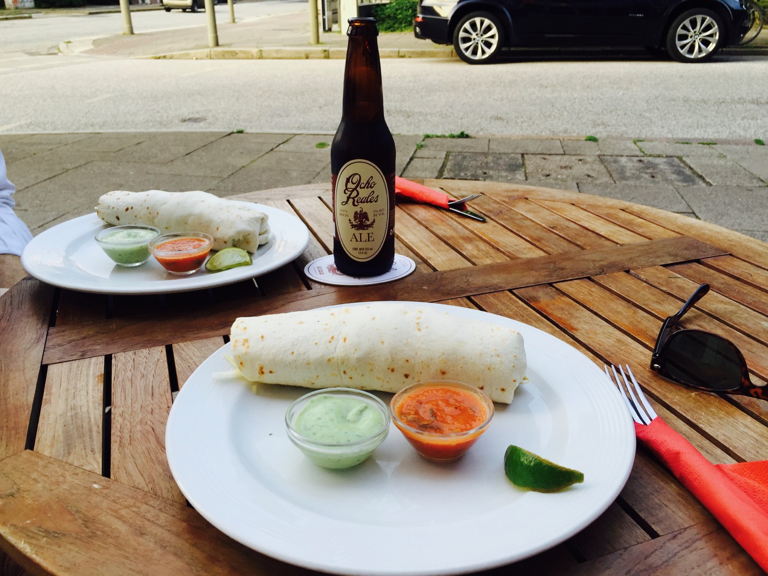 a burrito and a beer on a table