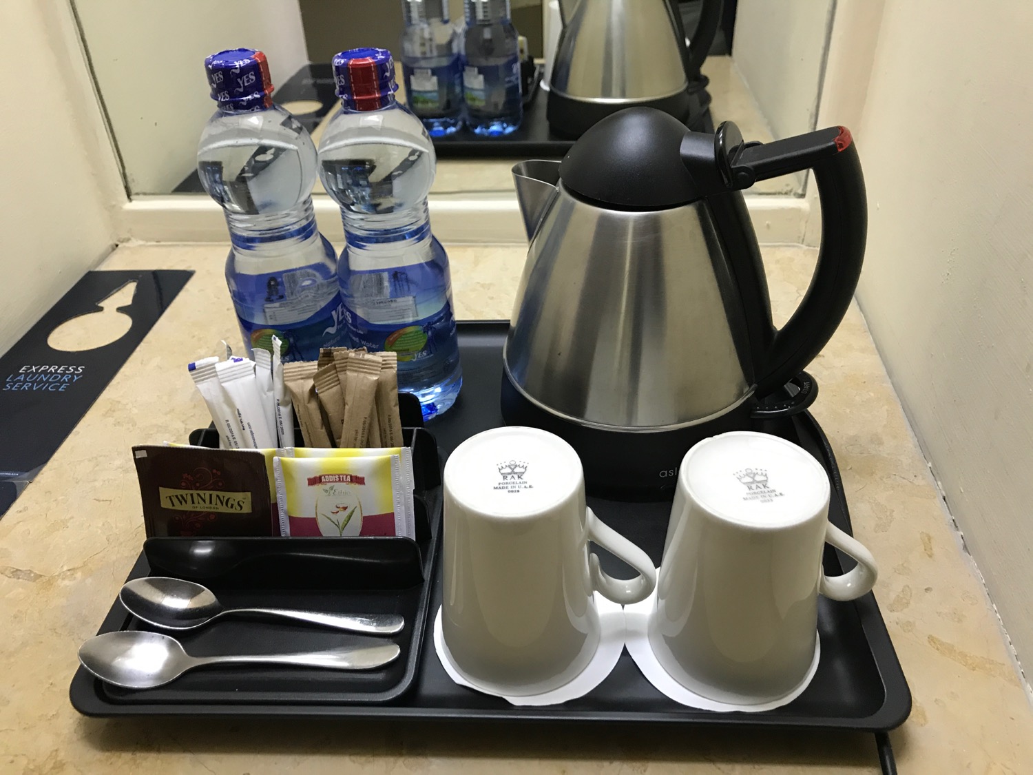 a tray with coffee pot and cups on it