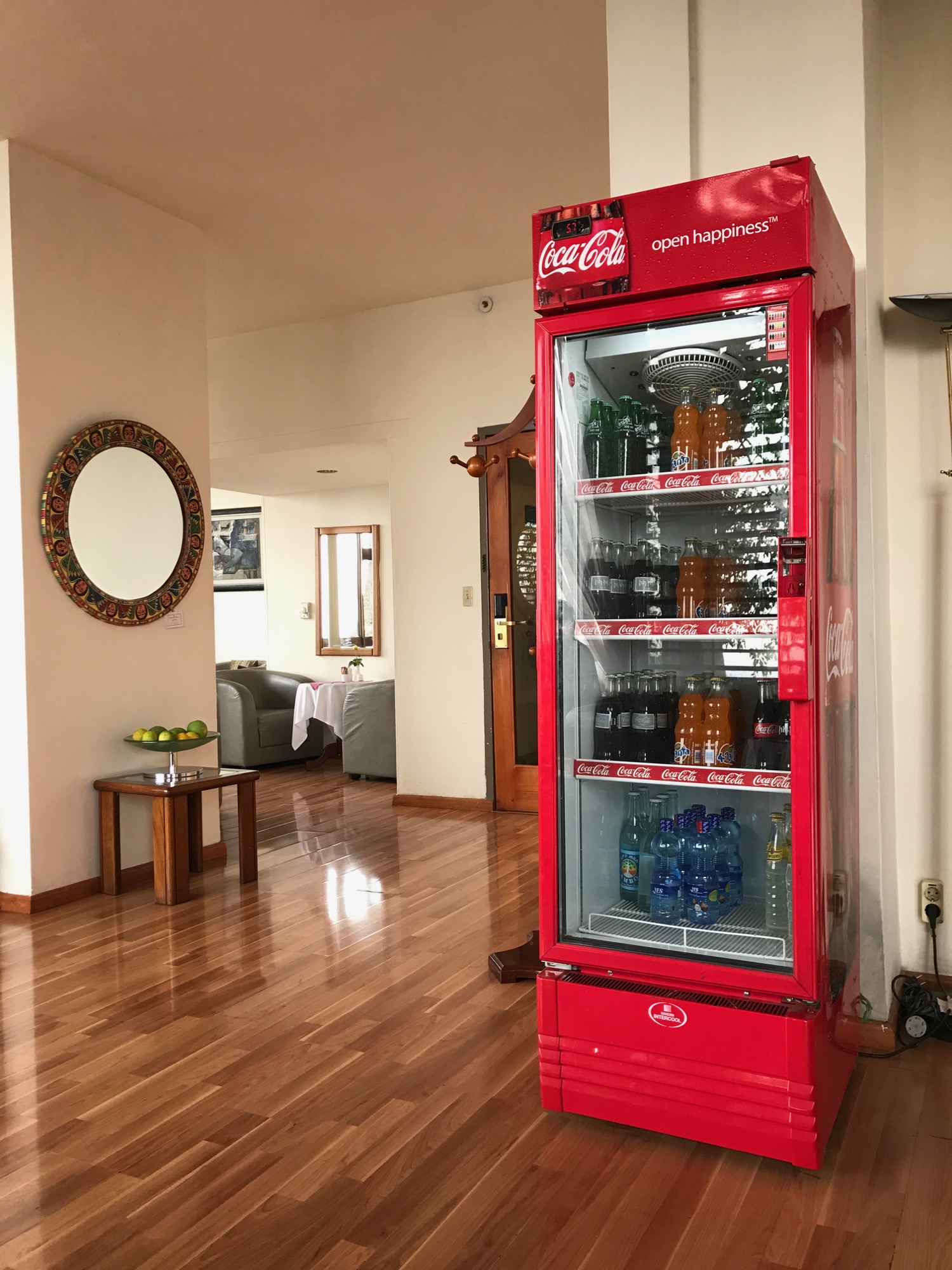 a red refrigerator with drinks in it