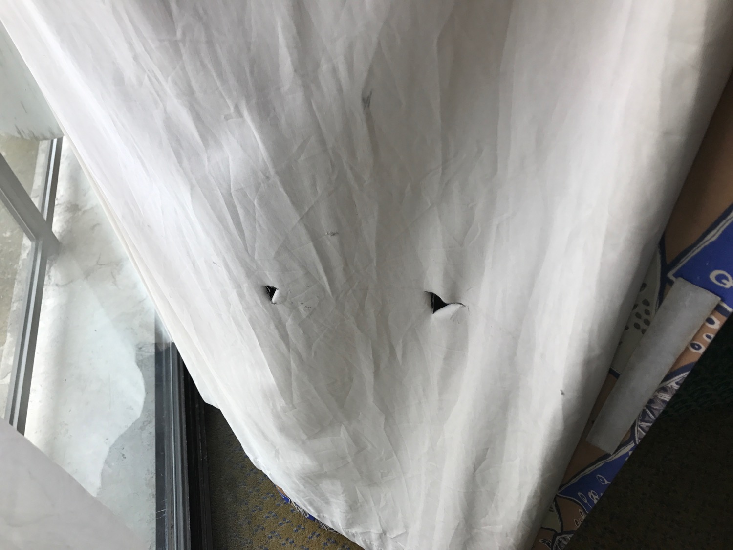 a white sheet with a hole in it