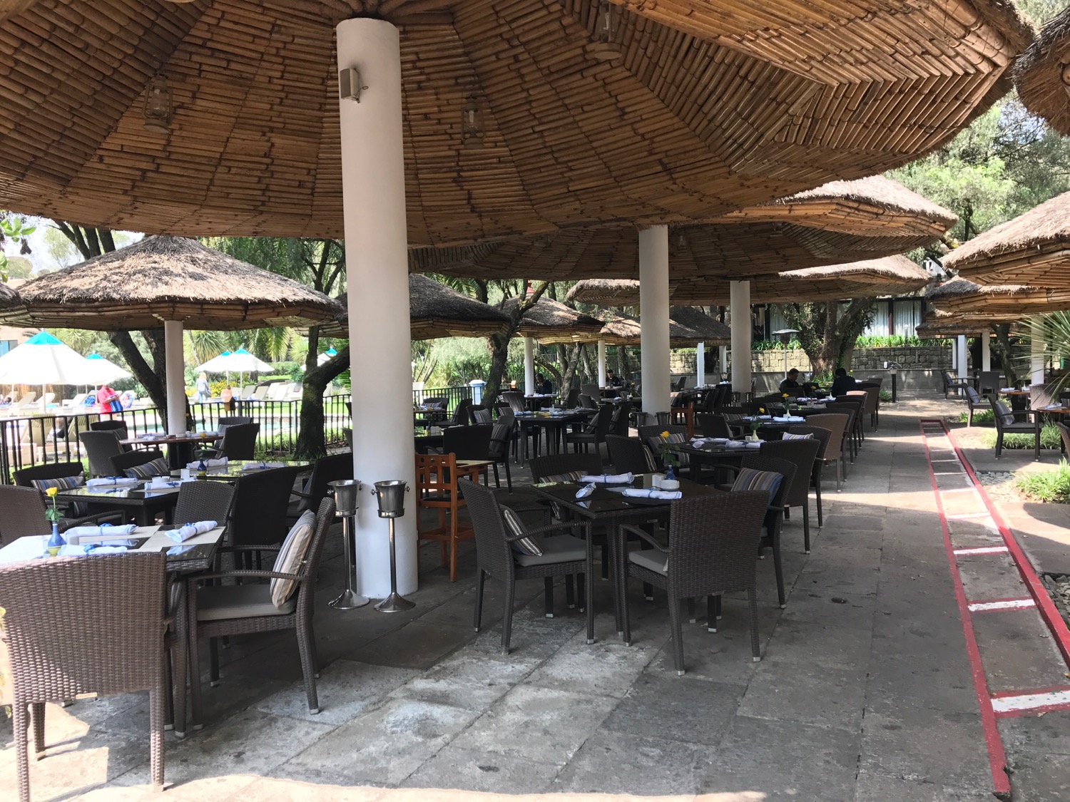 a restaurant with tables and umbrellas