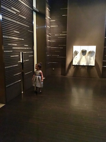 Lucy selects "up" from the lobby lifts.