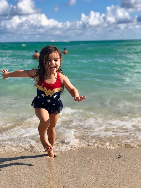 Our little Wonder Woman playing in the waves