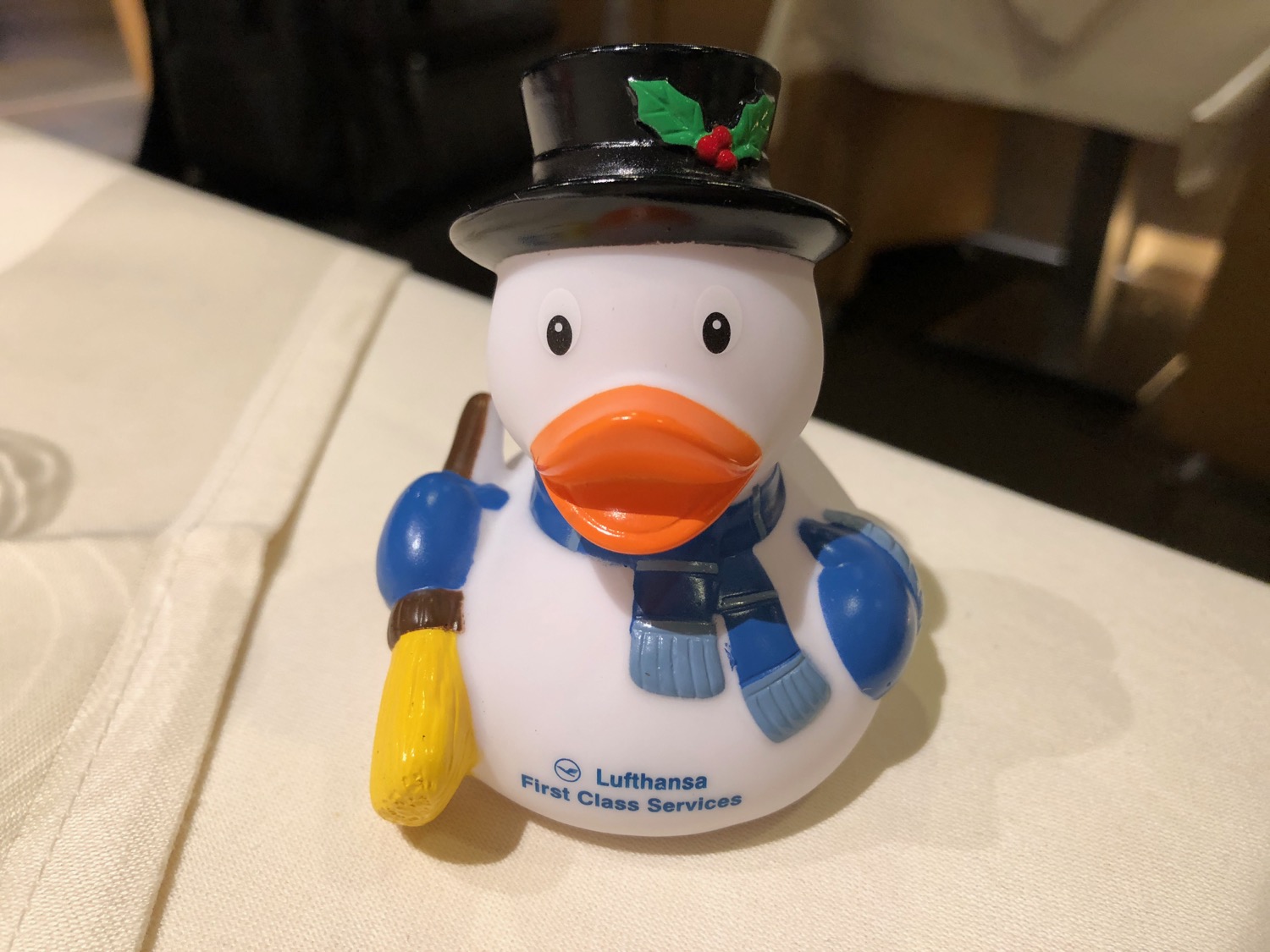a white rubber duck with a hat and scarf
