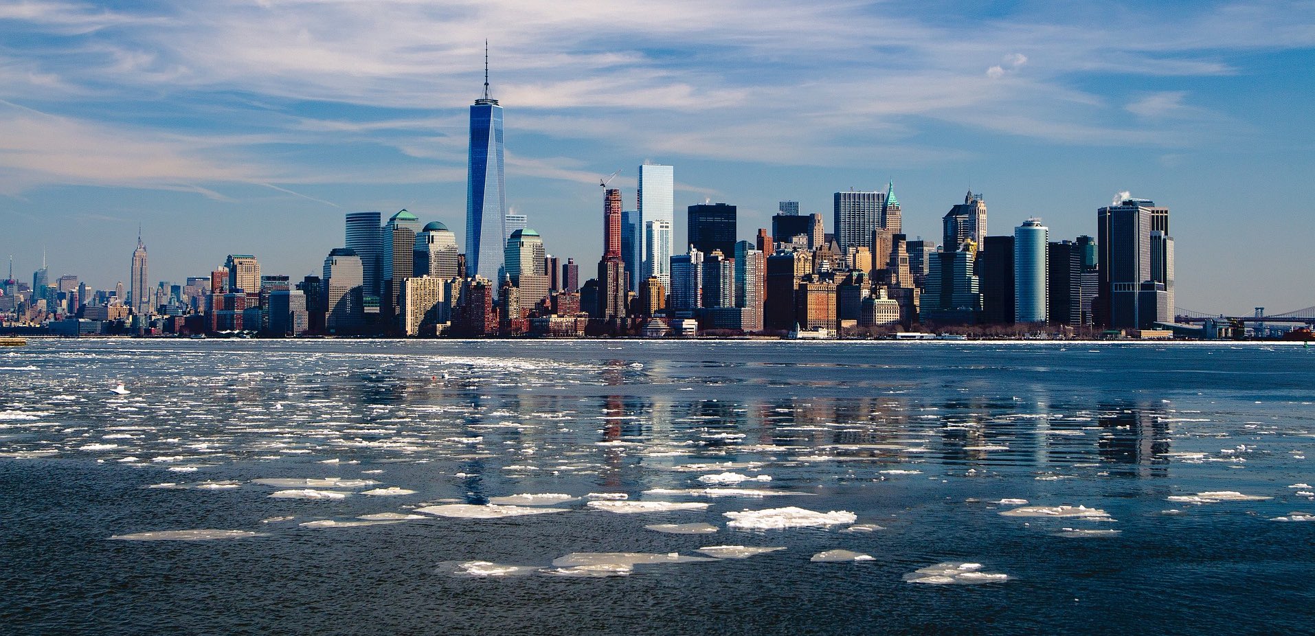 a city skyline with ice floating on water