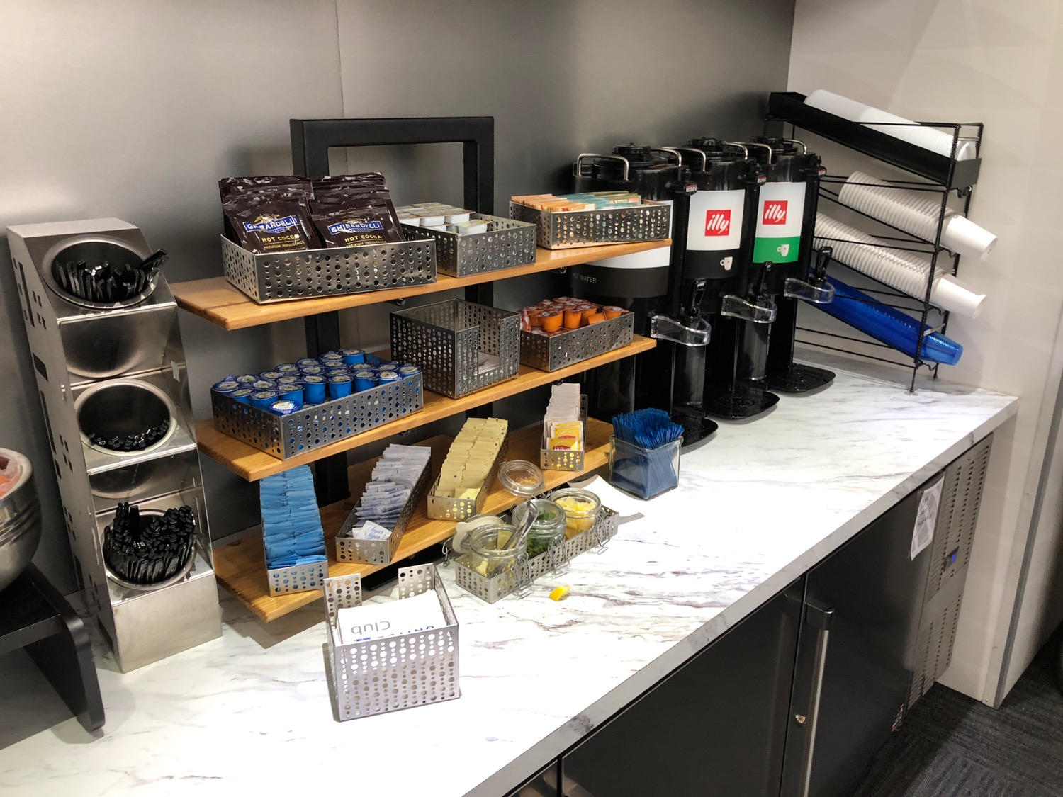 a counter with different types of coffee and condiments