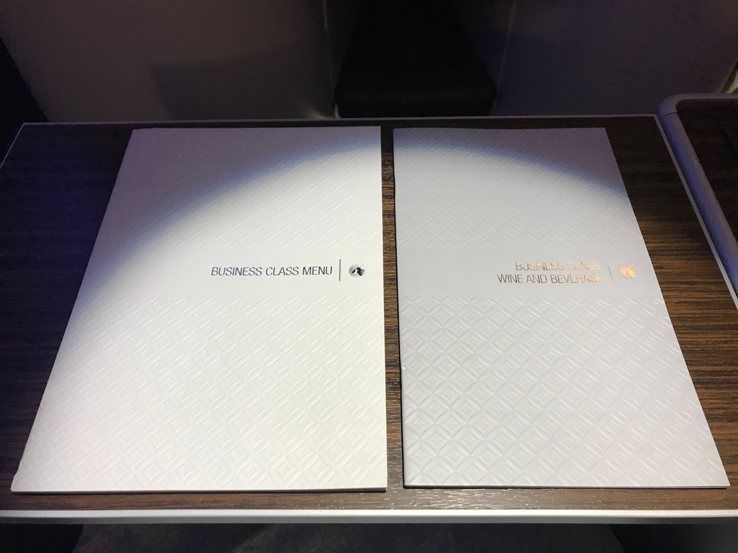a two white menus on a table