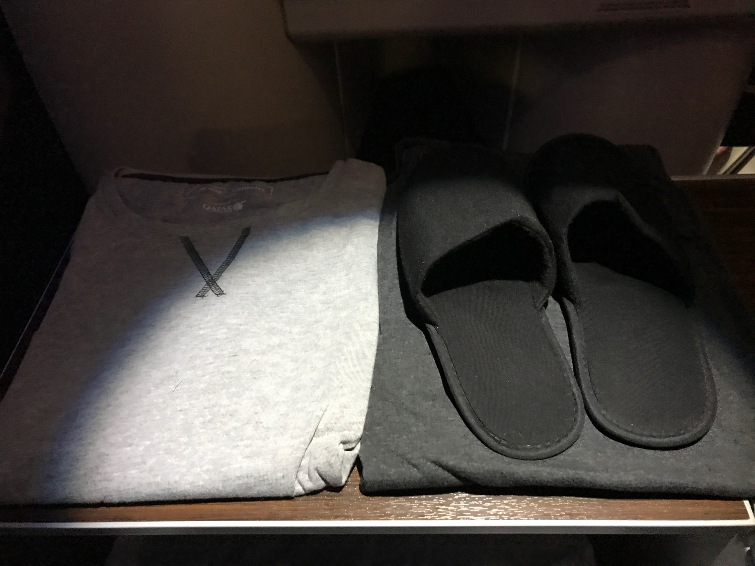 a pair of black and grey t-shirts and slippers