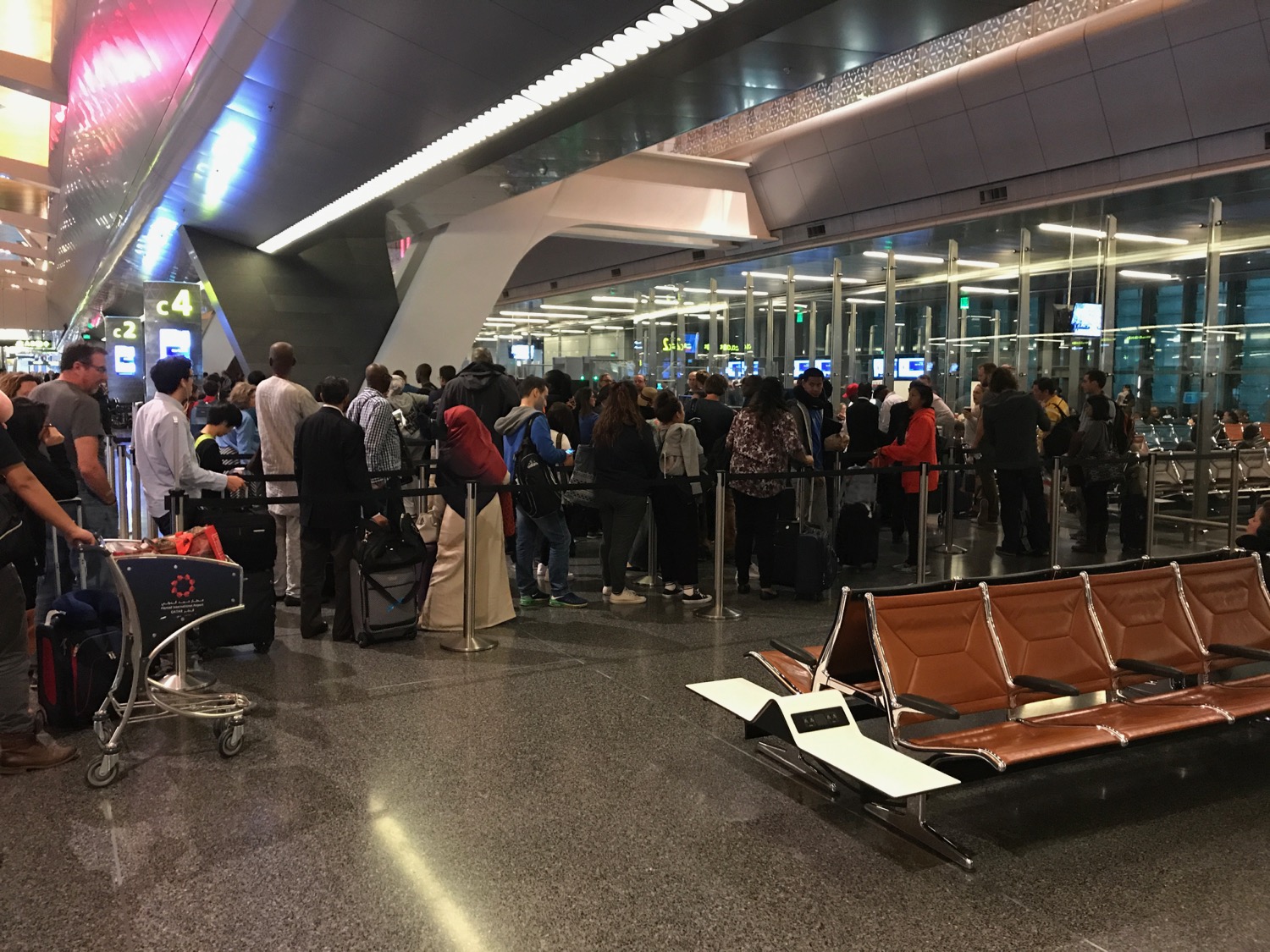a group of people standing in a line at an airport