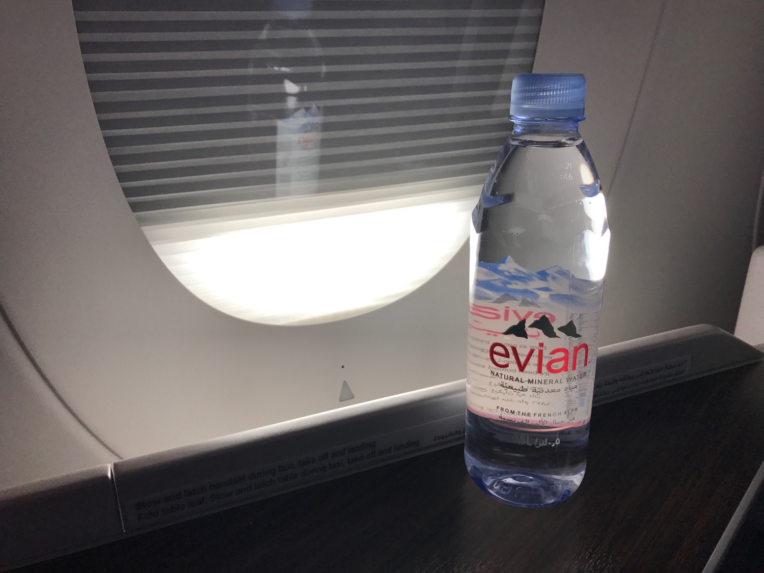 a bottle of water in front of a window