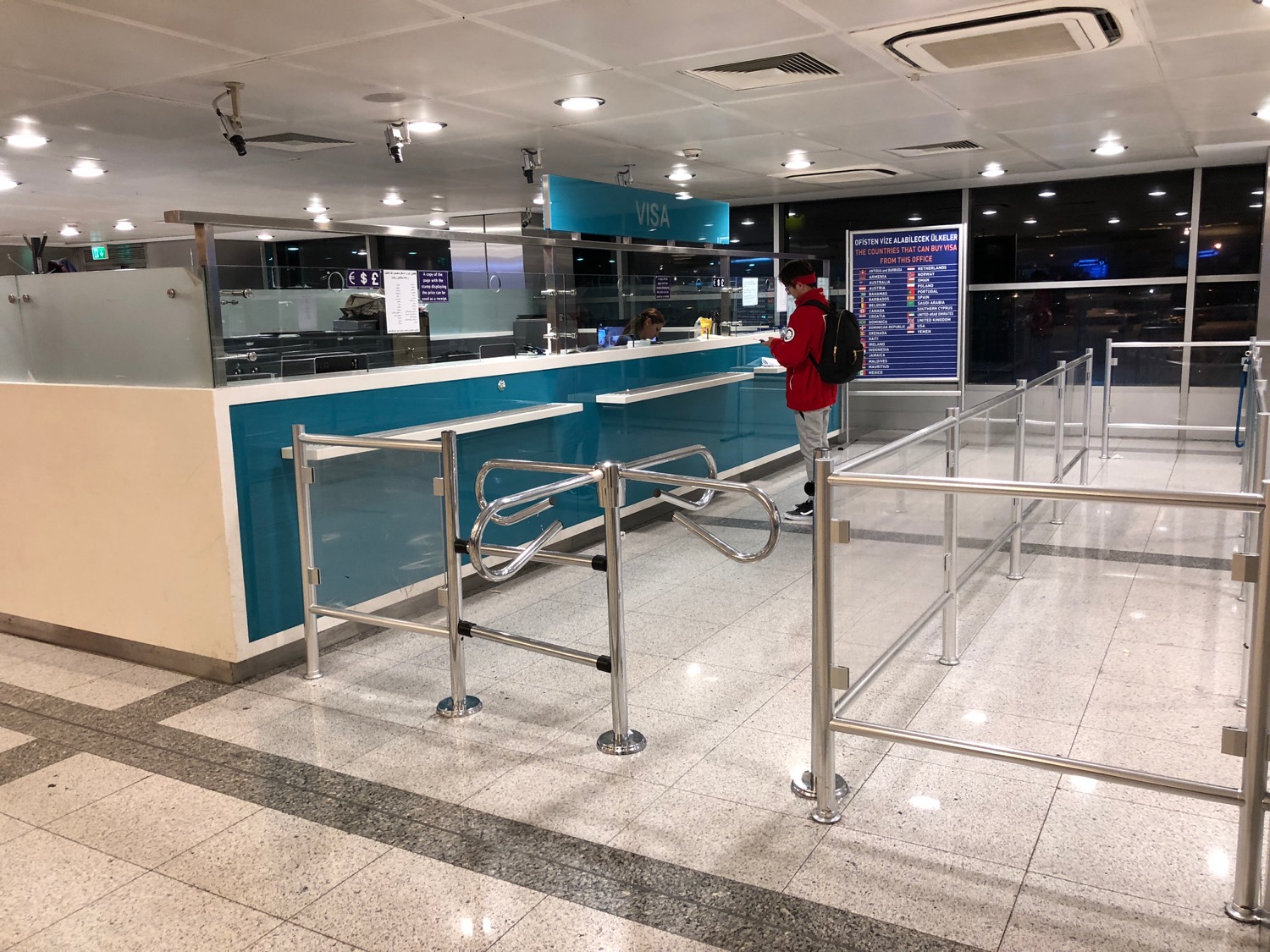 a person standing in front of a check-in counter