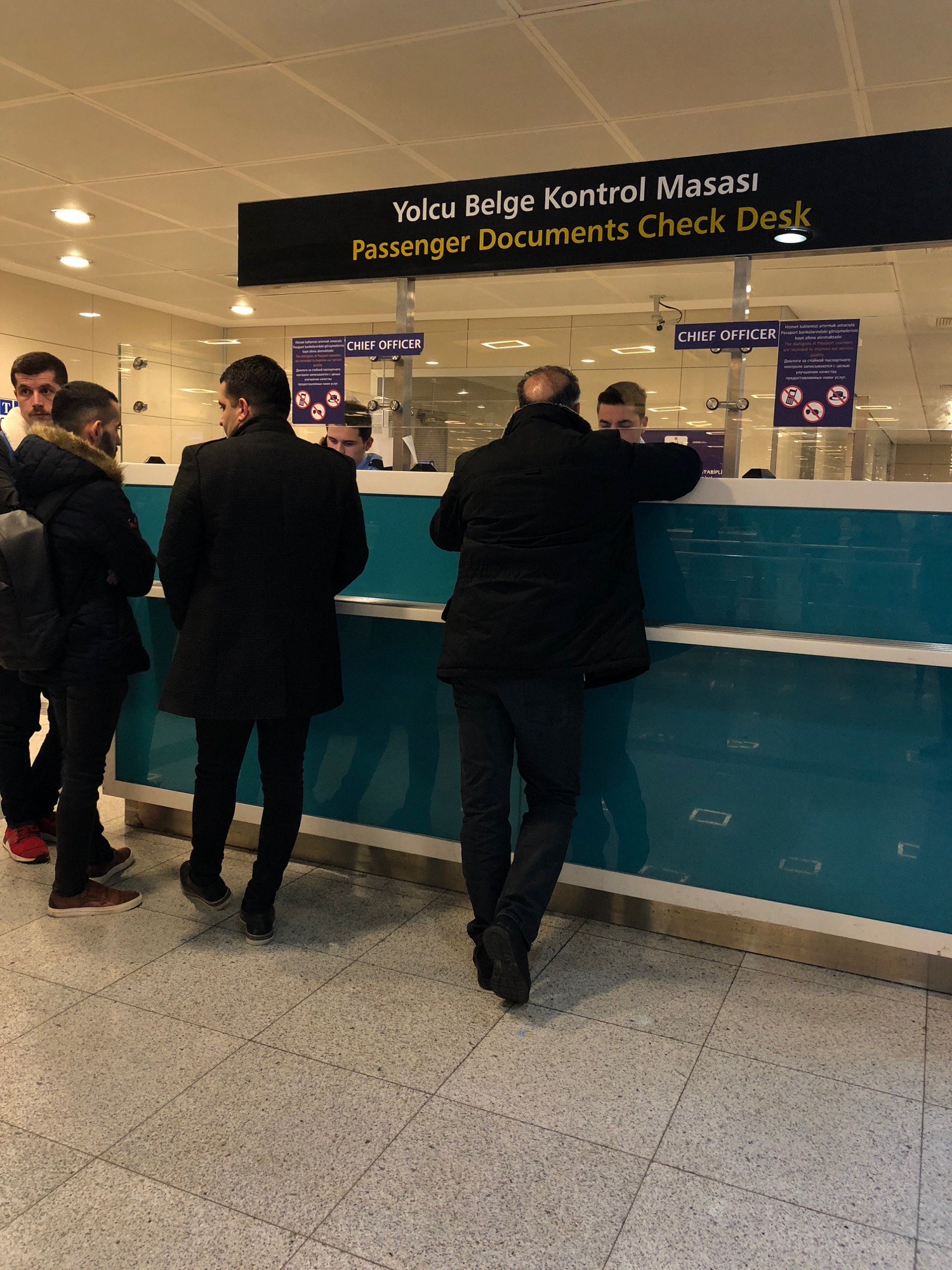 a group of people standing in front of a blue counter