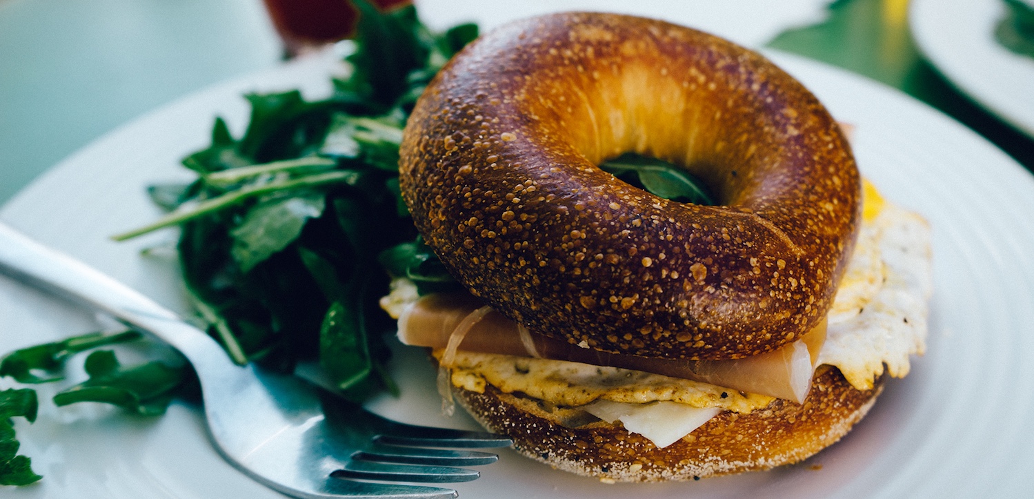 a bagel sandwich with a fork