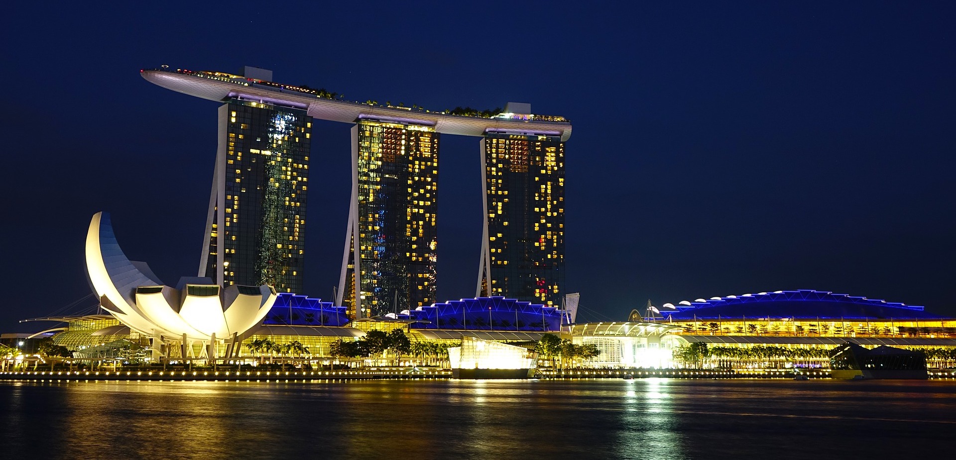 Marina Bay Sands skyline with lights and a body of water