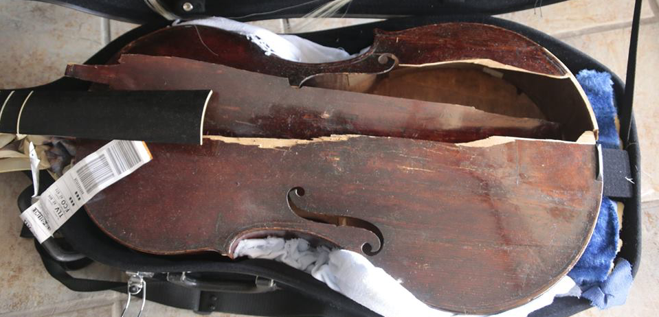 a broken violin in a case
