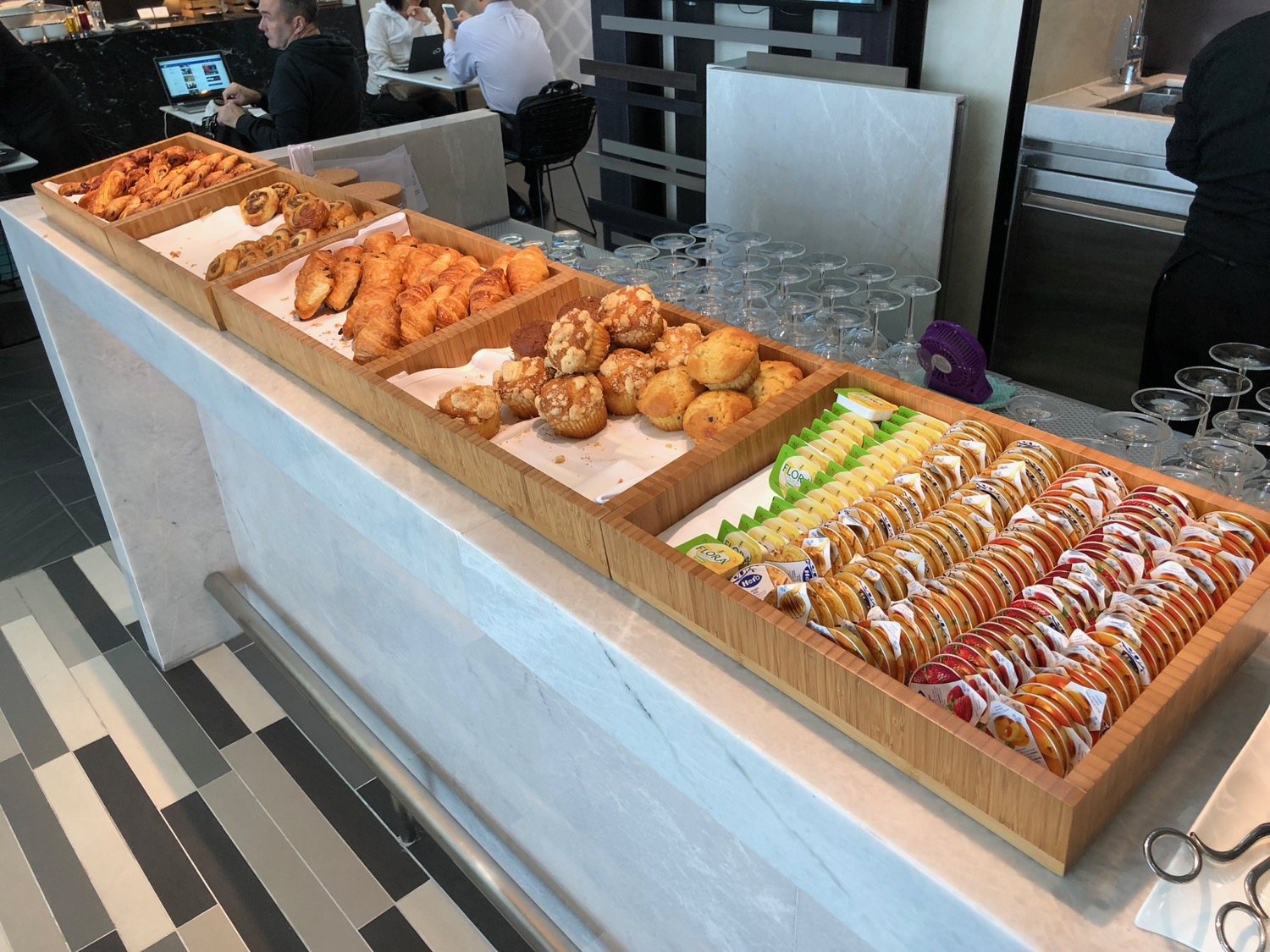 a row of trays of pastries