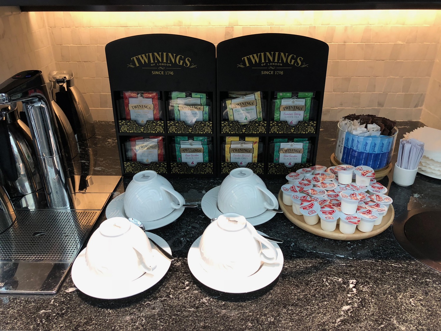 a group of cups and saucers on a counter