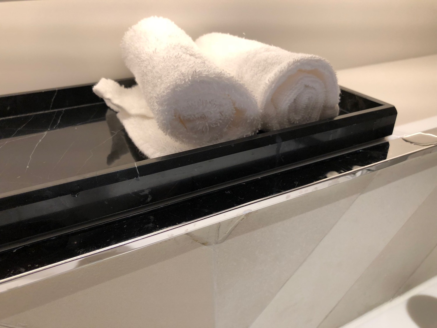 a white towels on a black tray