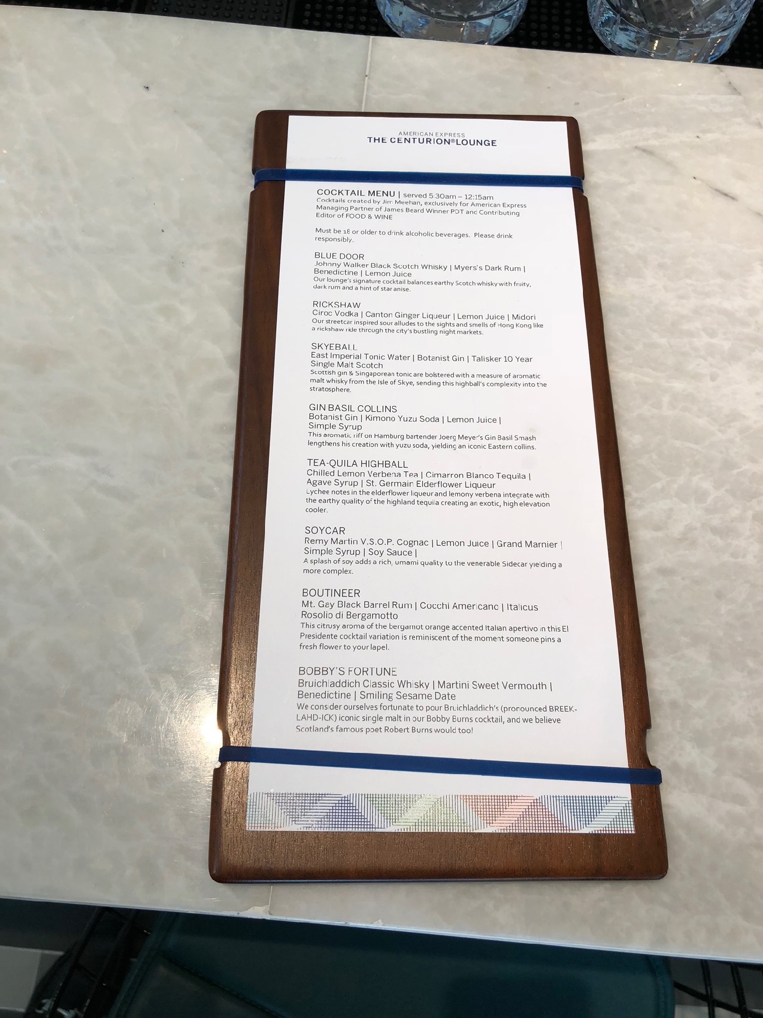 a menu with a wooden frame and blue rubber bands