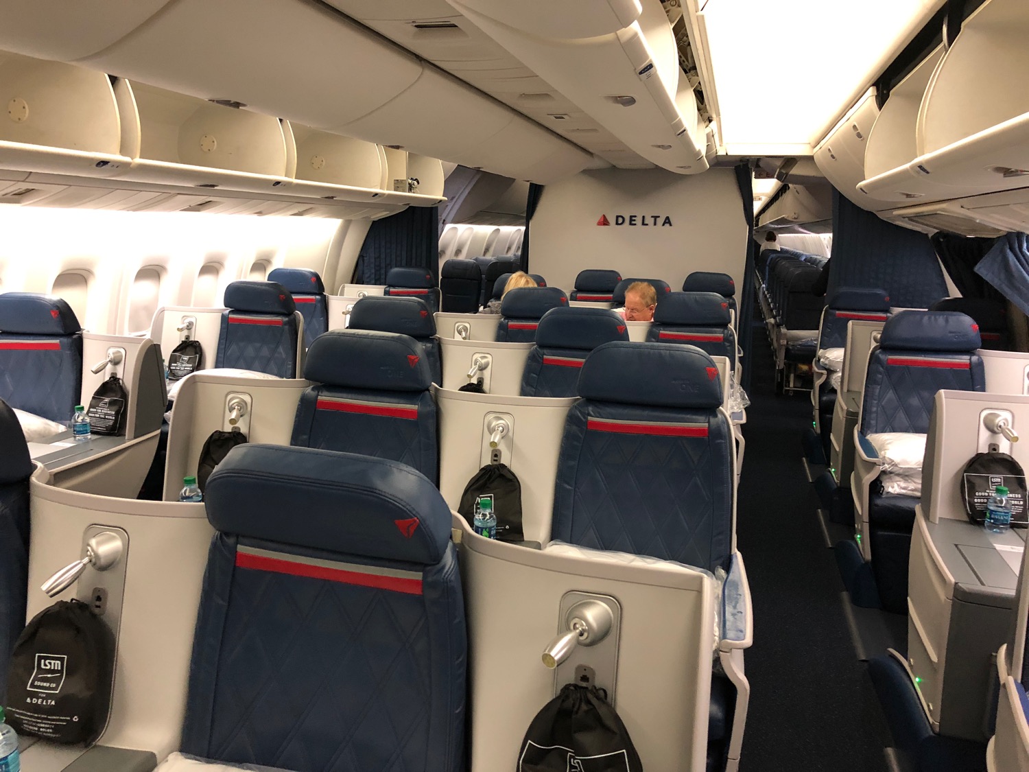 a plane with seats and people sitting in it
