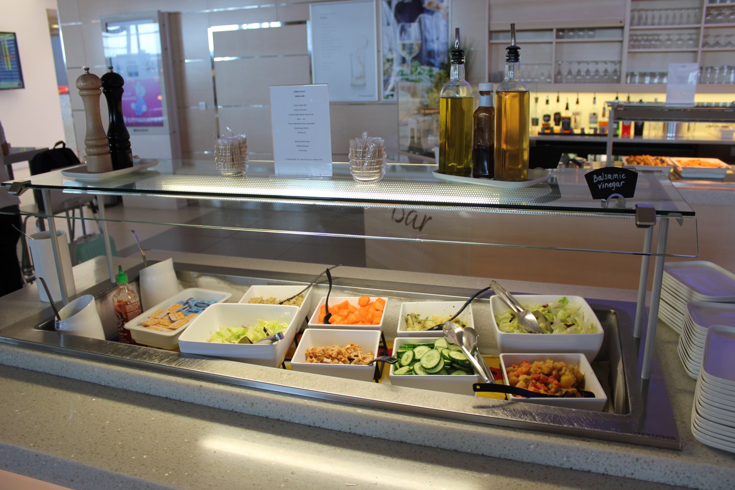 a salad bar with different salads in bowls