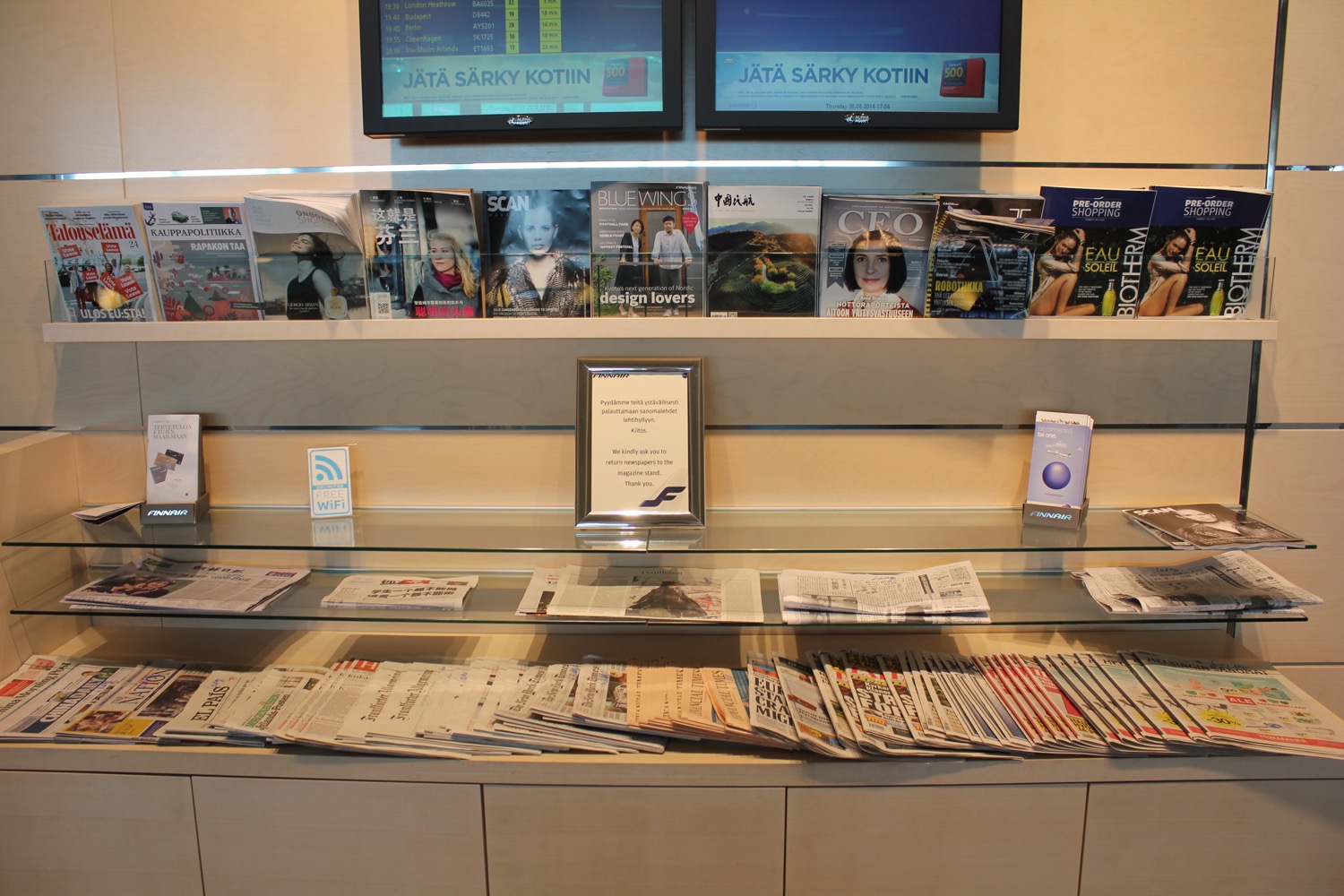 a display of magazines and a television on a shelf