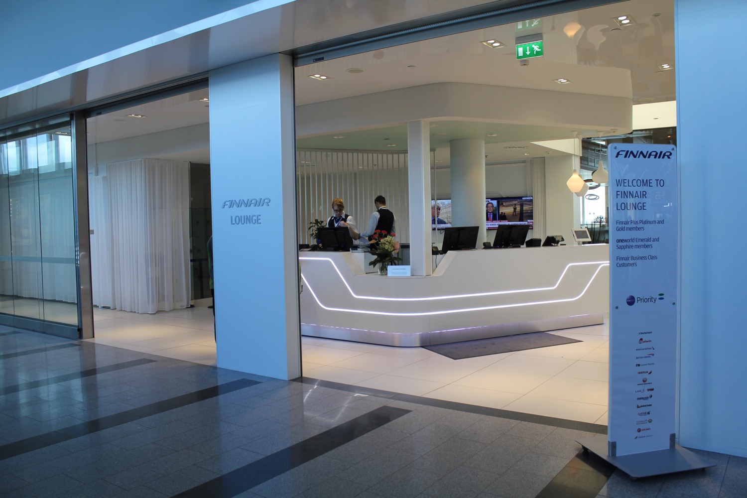 a white reception desk with people behind it