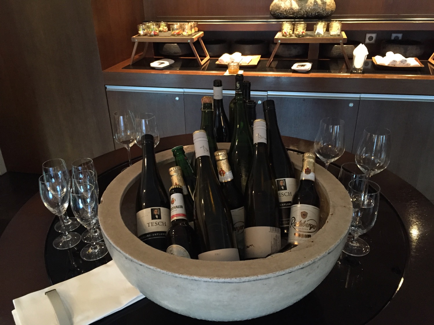 a bowl of wine bottles and glasses