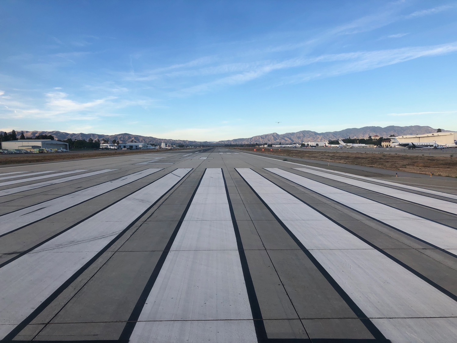 a runway with a view of mountains in the background