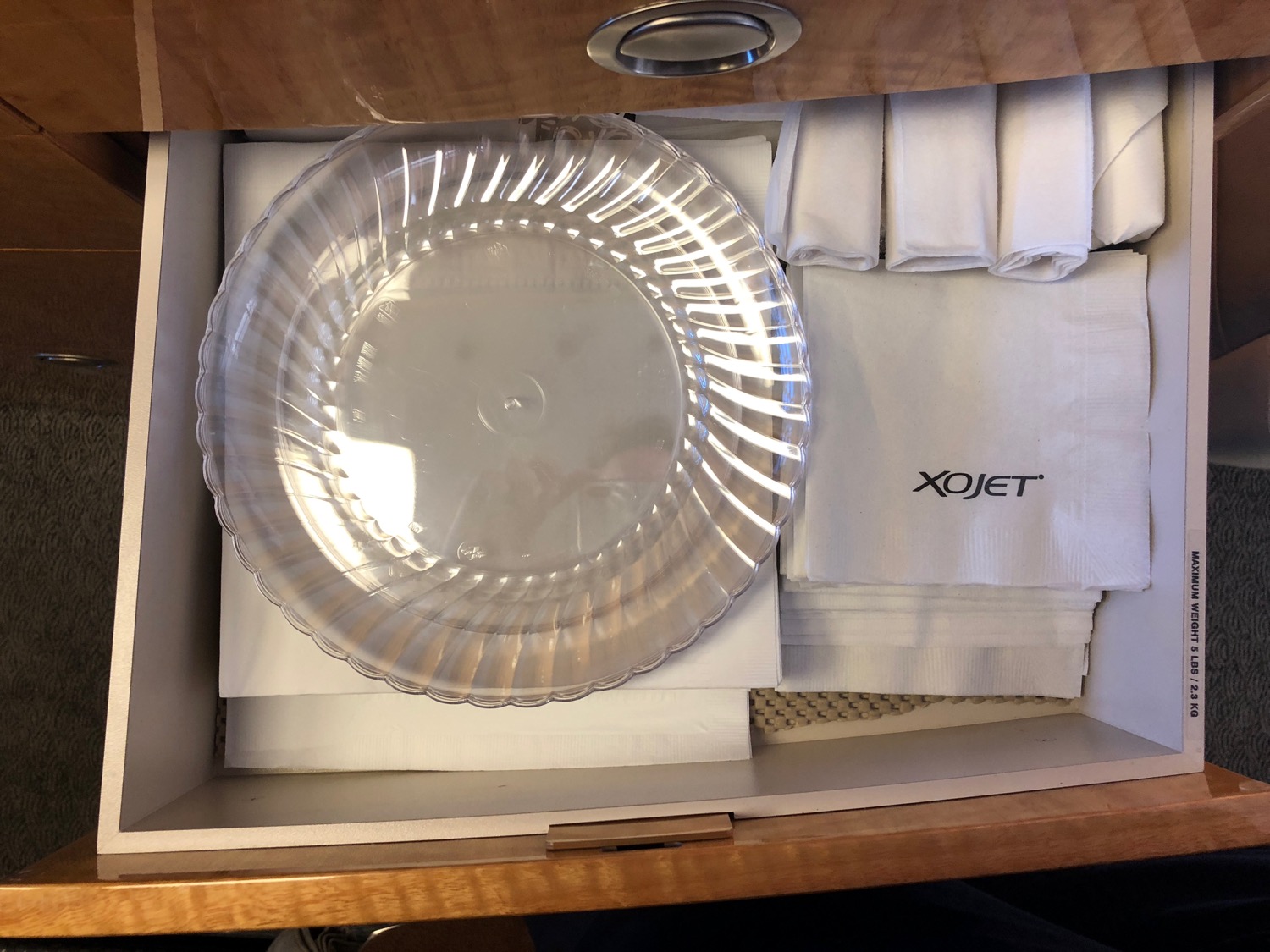 a clear plate and napkins in a drawer
