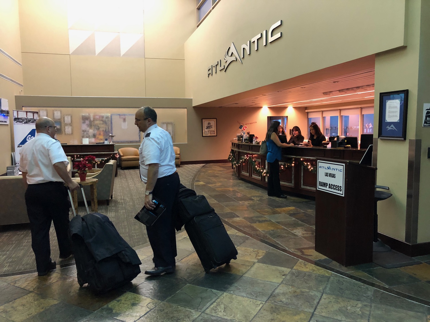 a group of people with luggage in a lobby