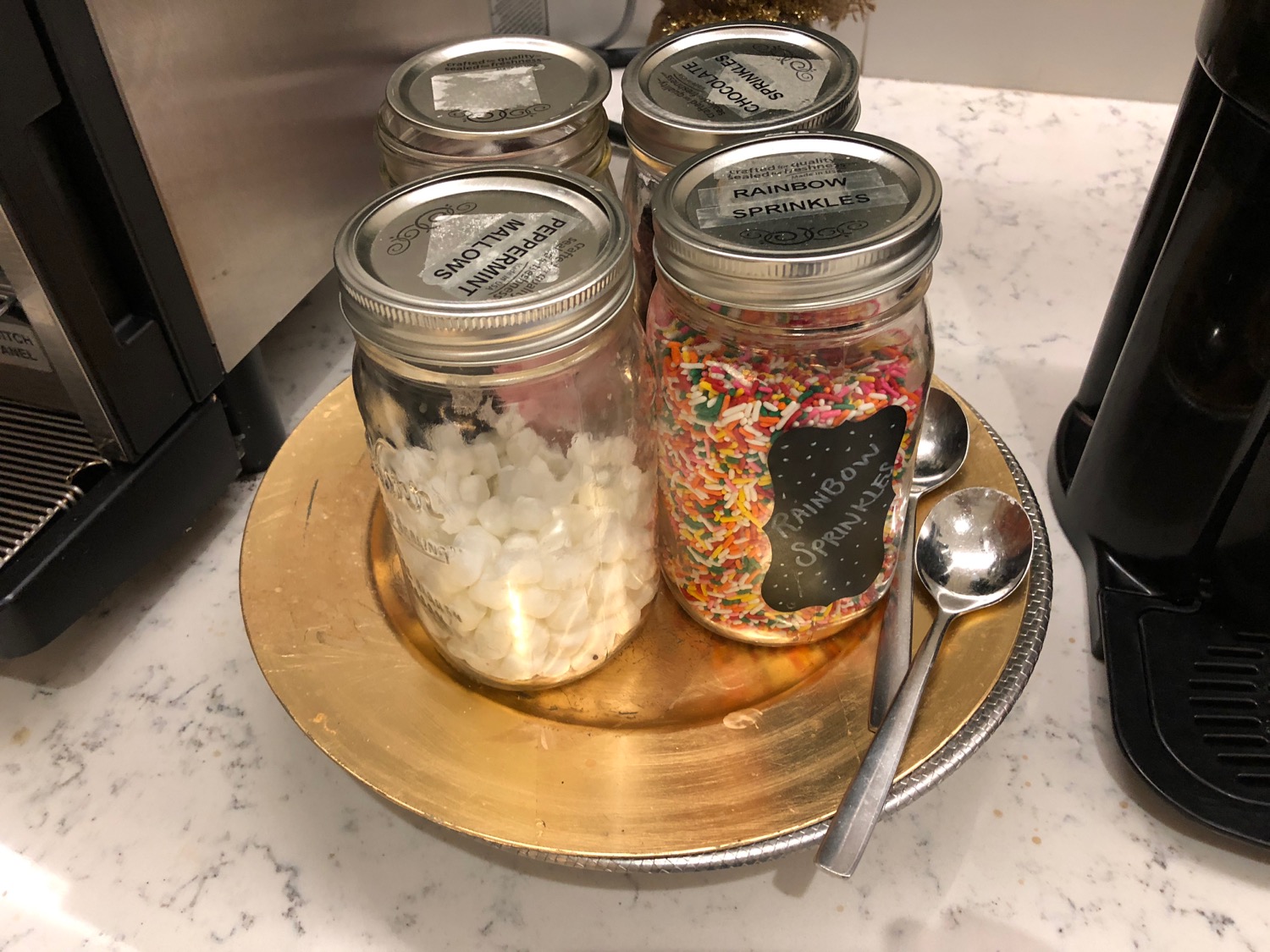 a group of jars with sprinkles on a plate