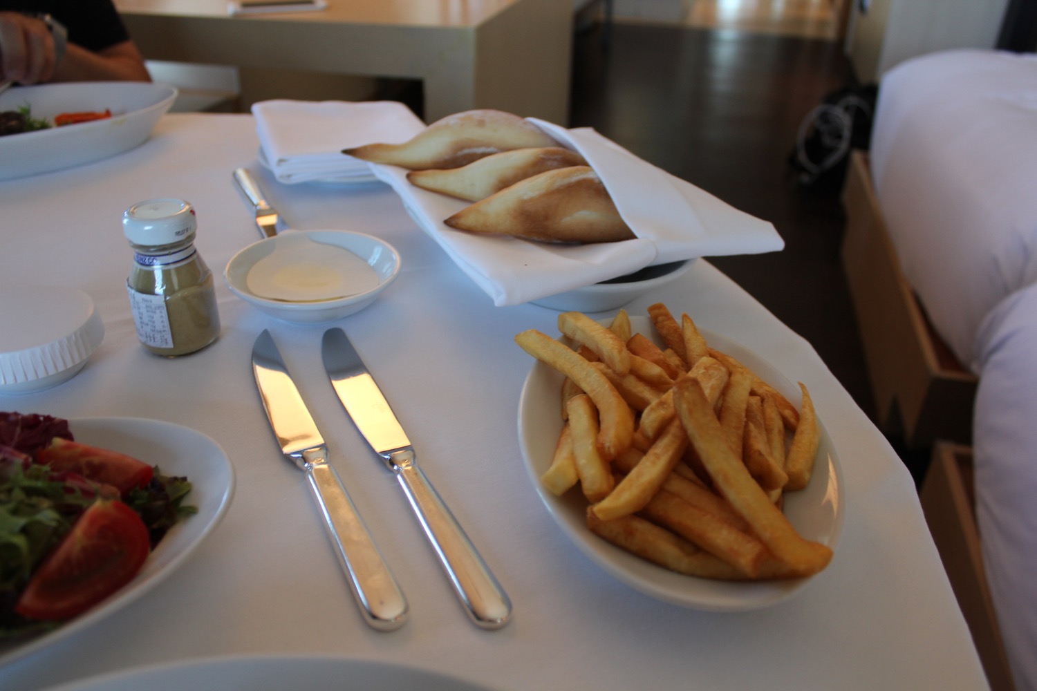 a plate of french fries and bread on a table