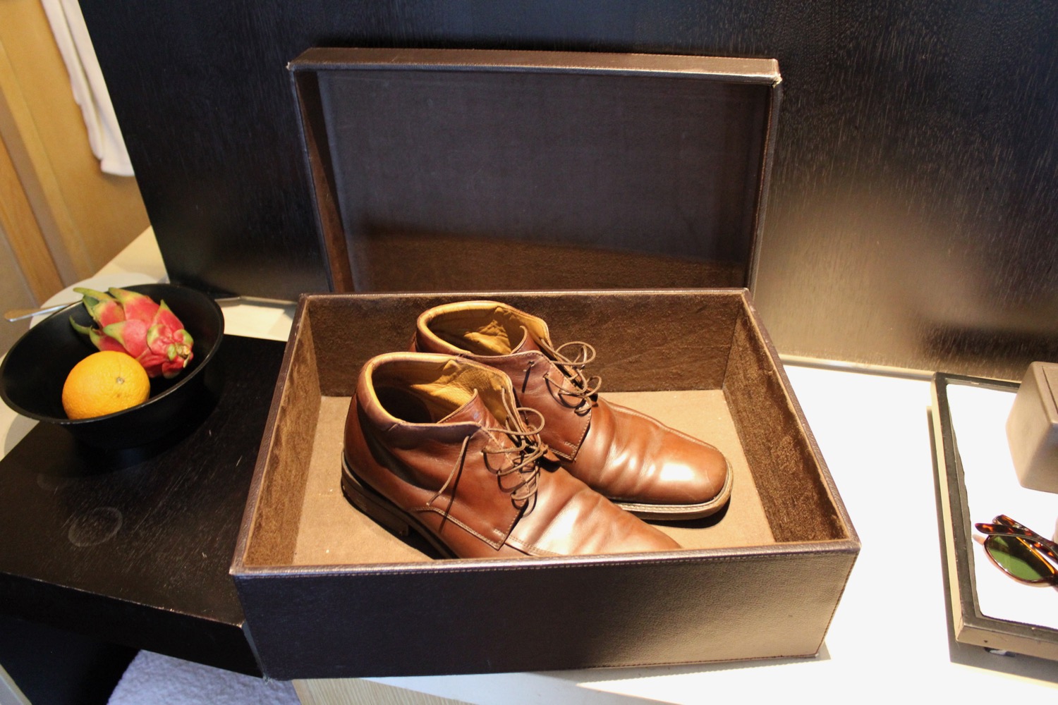 a pair of brown shoes in a box