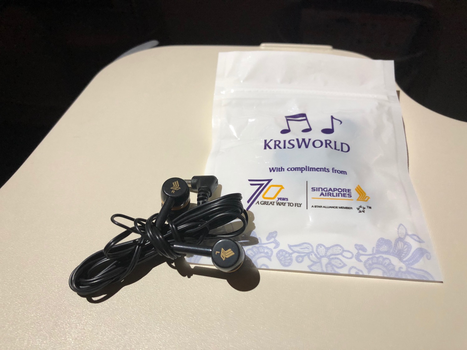 a black earbuds and a white bag