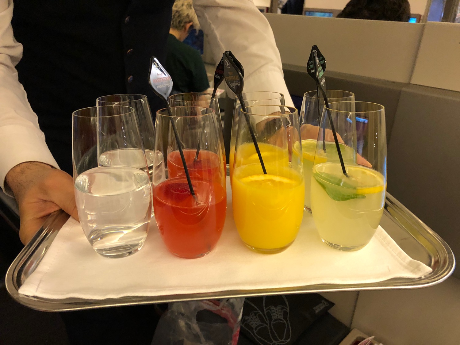 a tray of drinks with straws