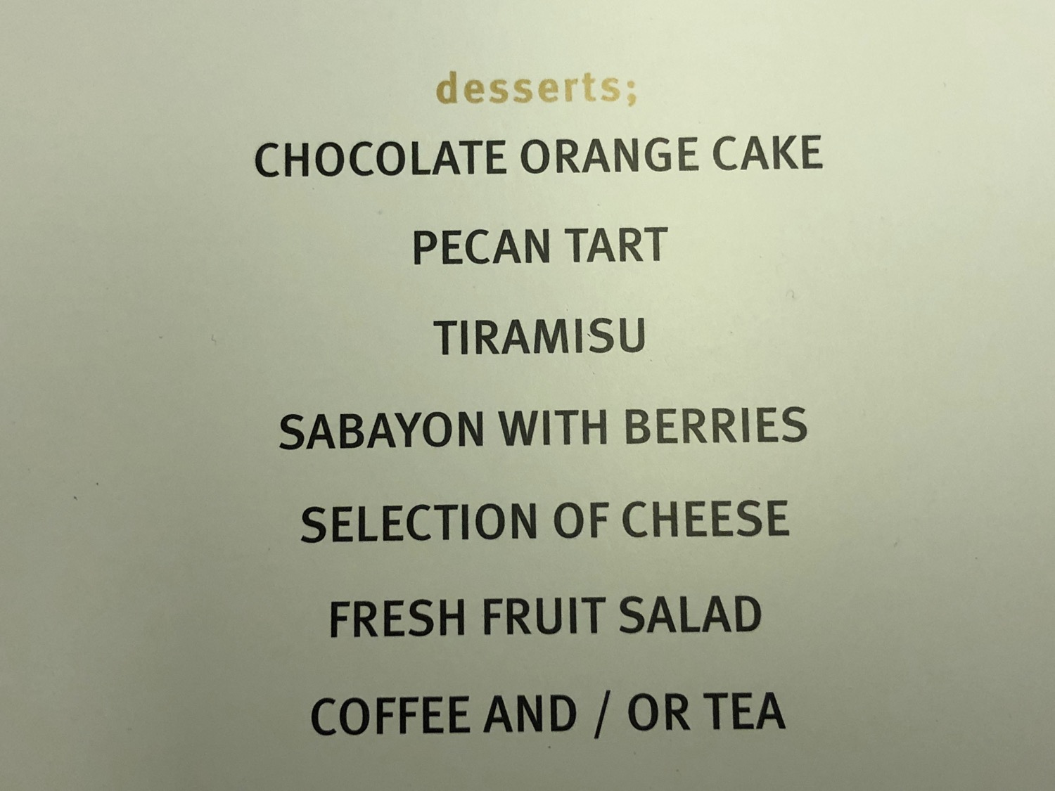 a menu of desserts on a white surface