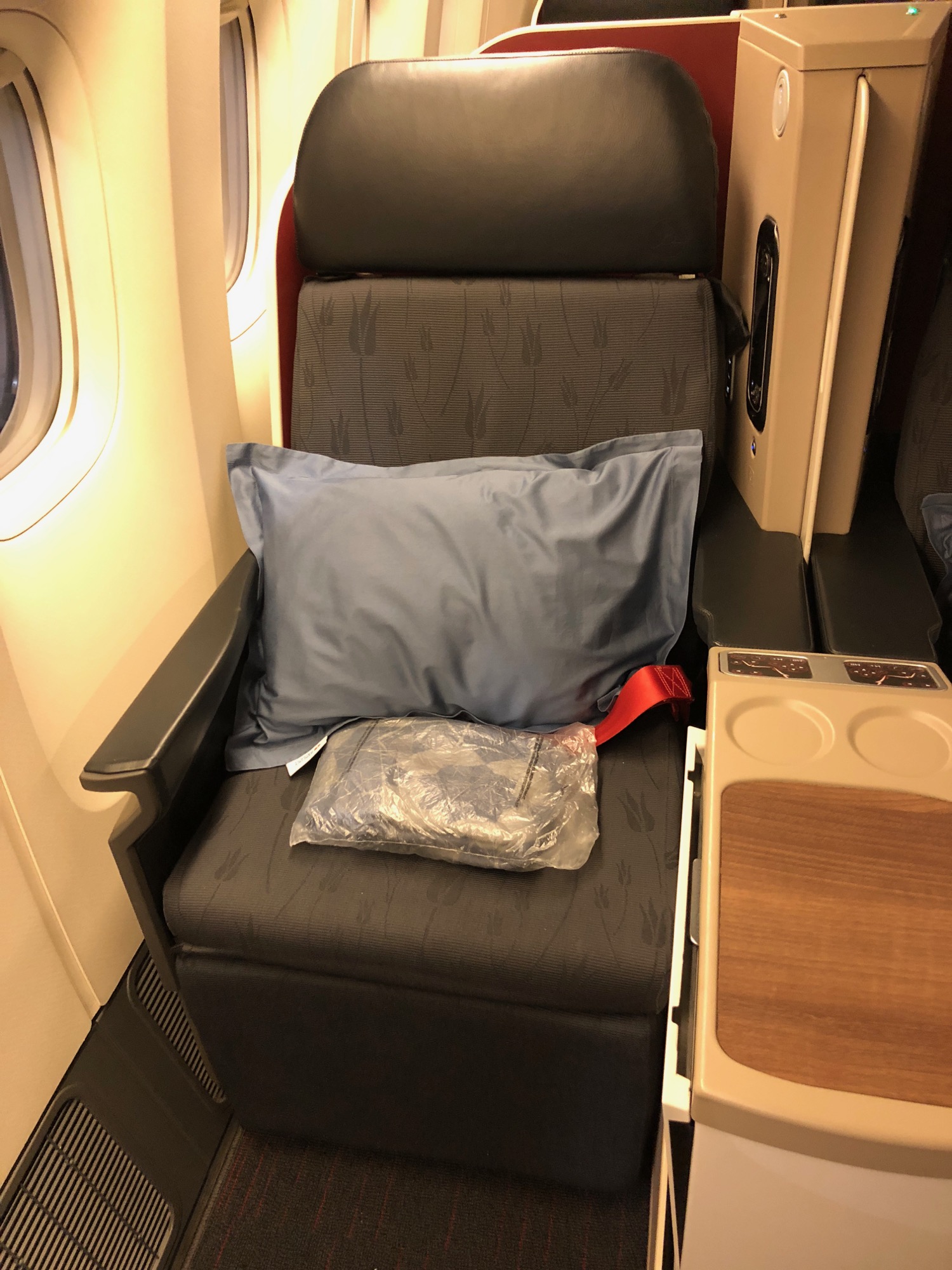 a seat with a pillow and a bag on it