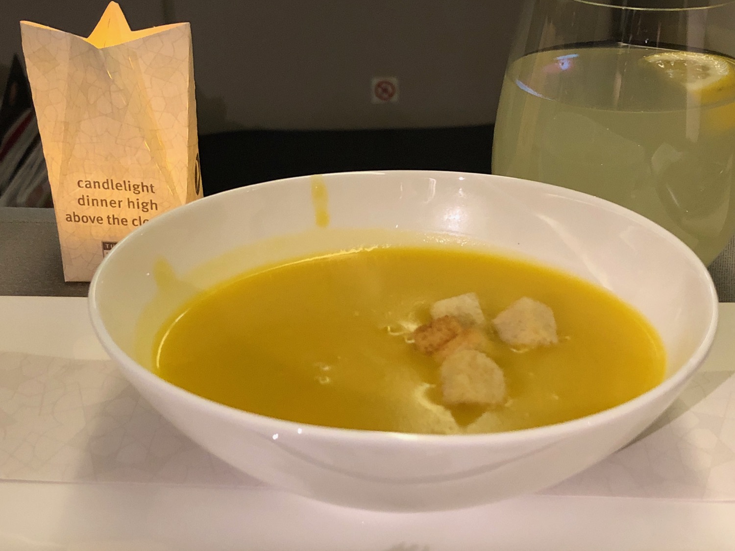 a bowl of soup with croutons in it