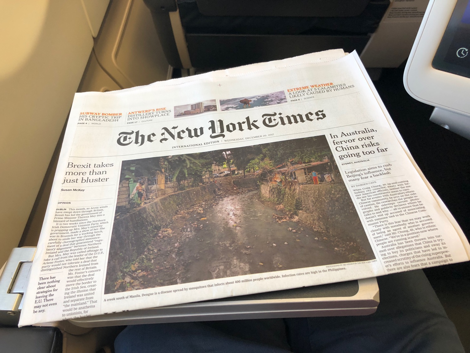a newspaper on a person's lap