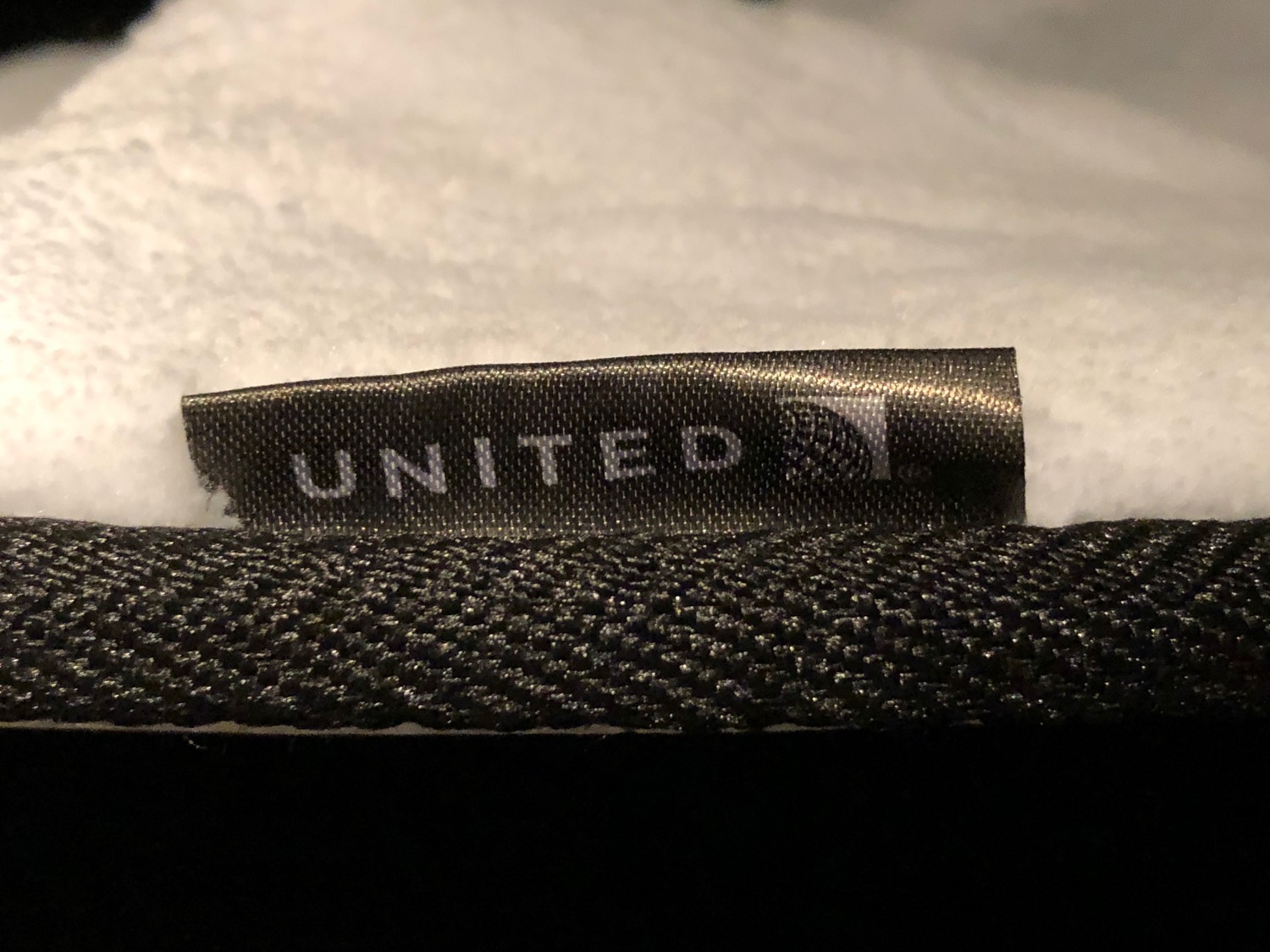 a black label on a white fabric