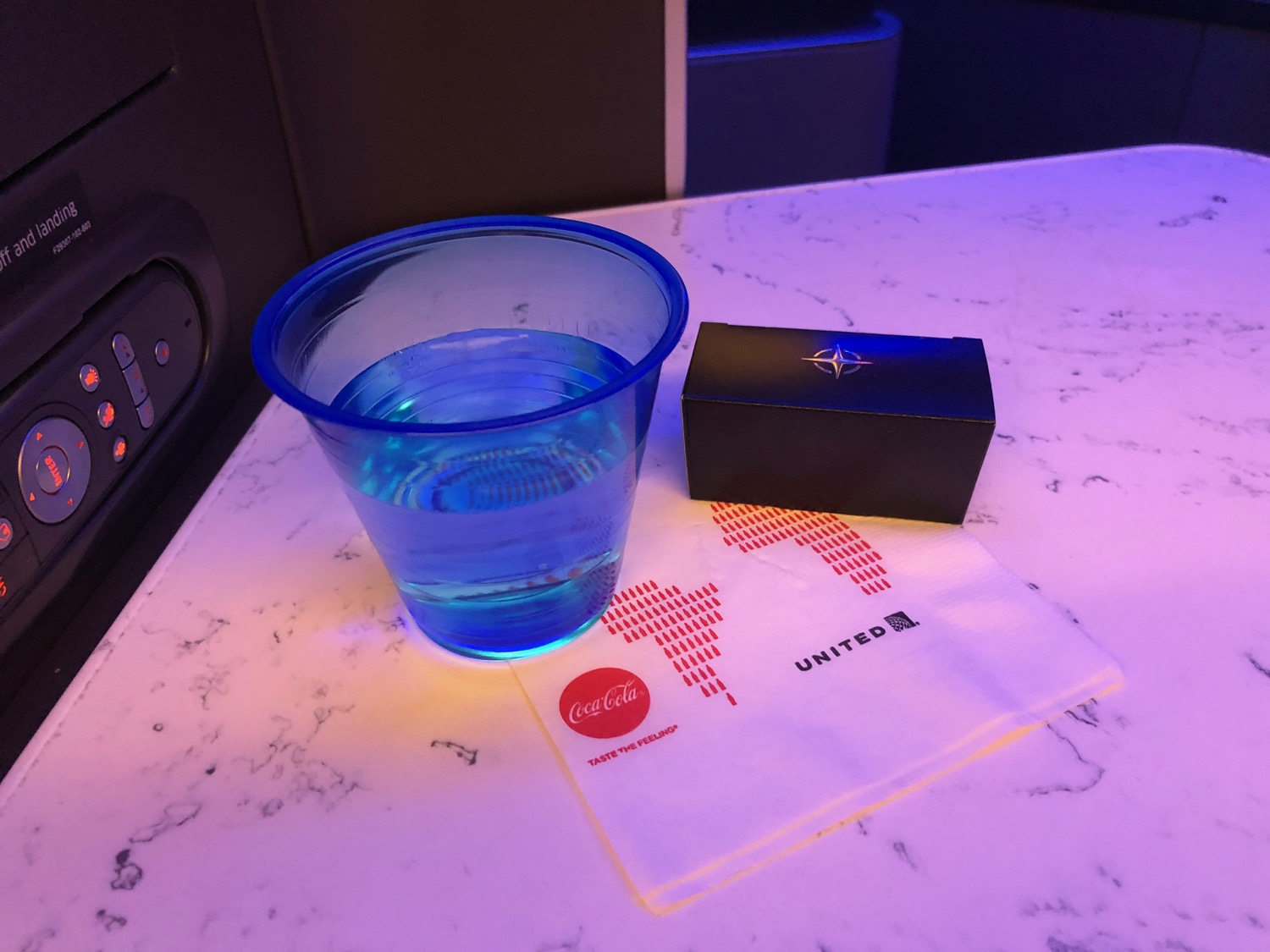 a cup of water and a box on a table