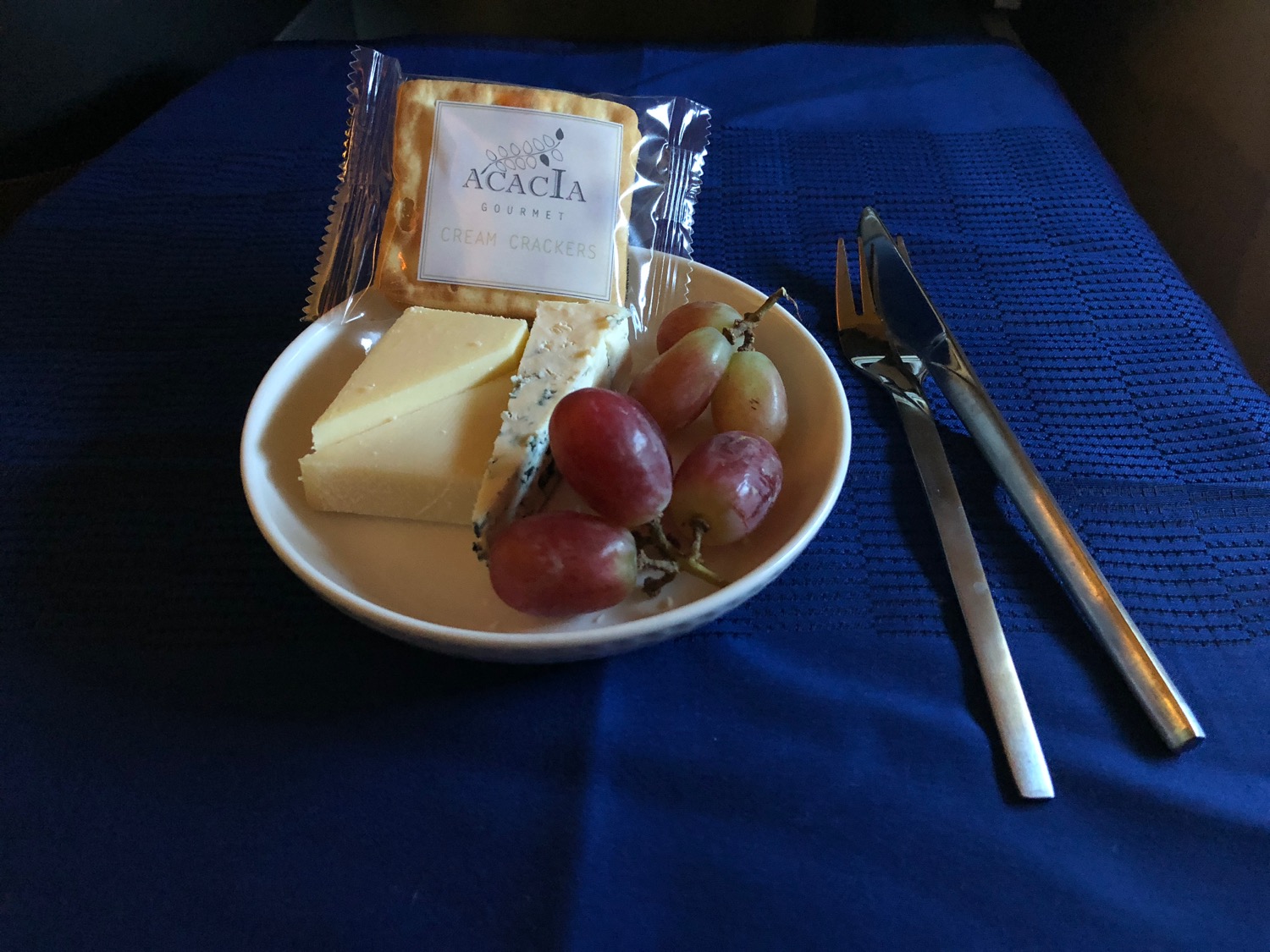 a plate of food with grapes and crackers