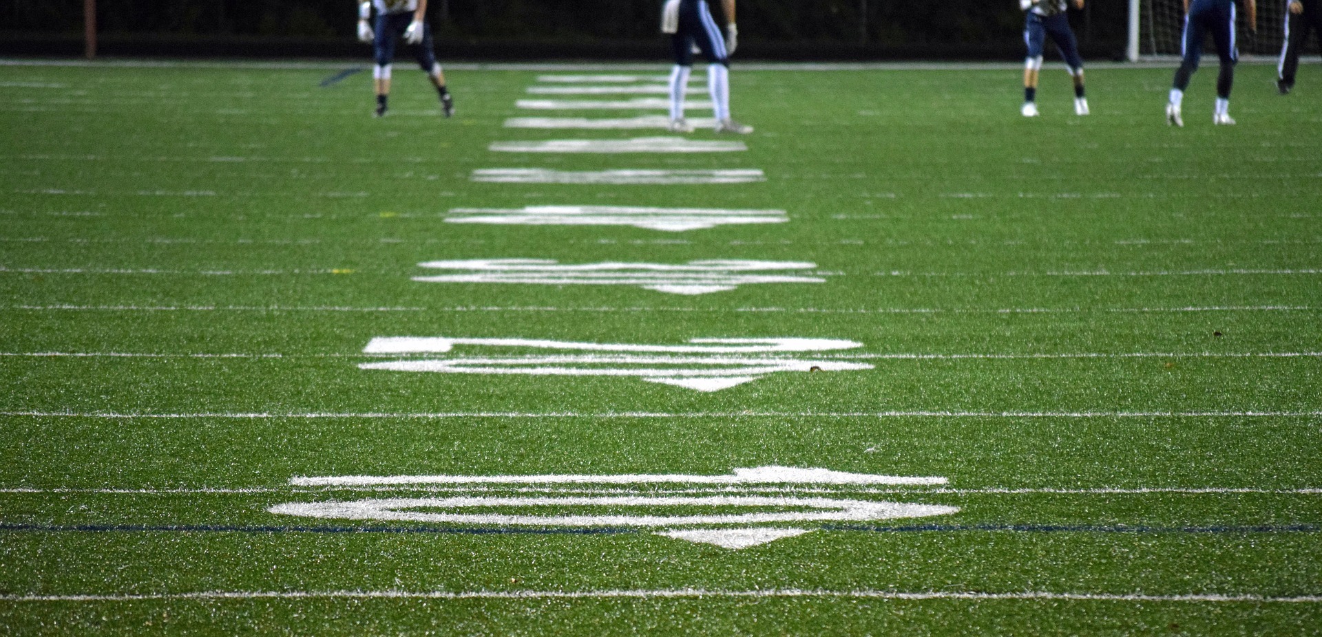 a football field with white arrows