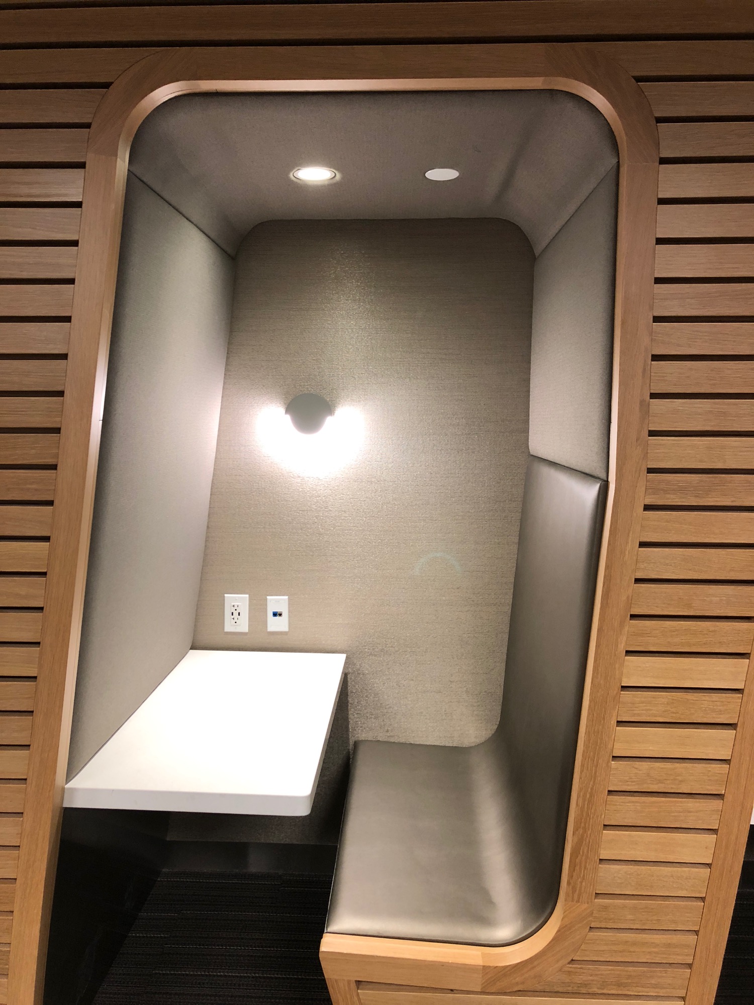 a small booth with a table and a light in the middle