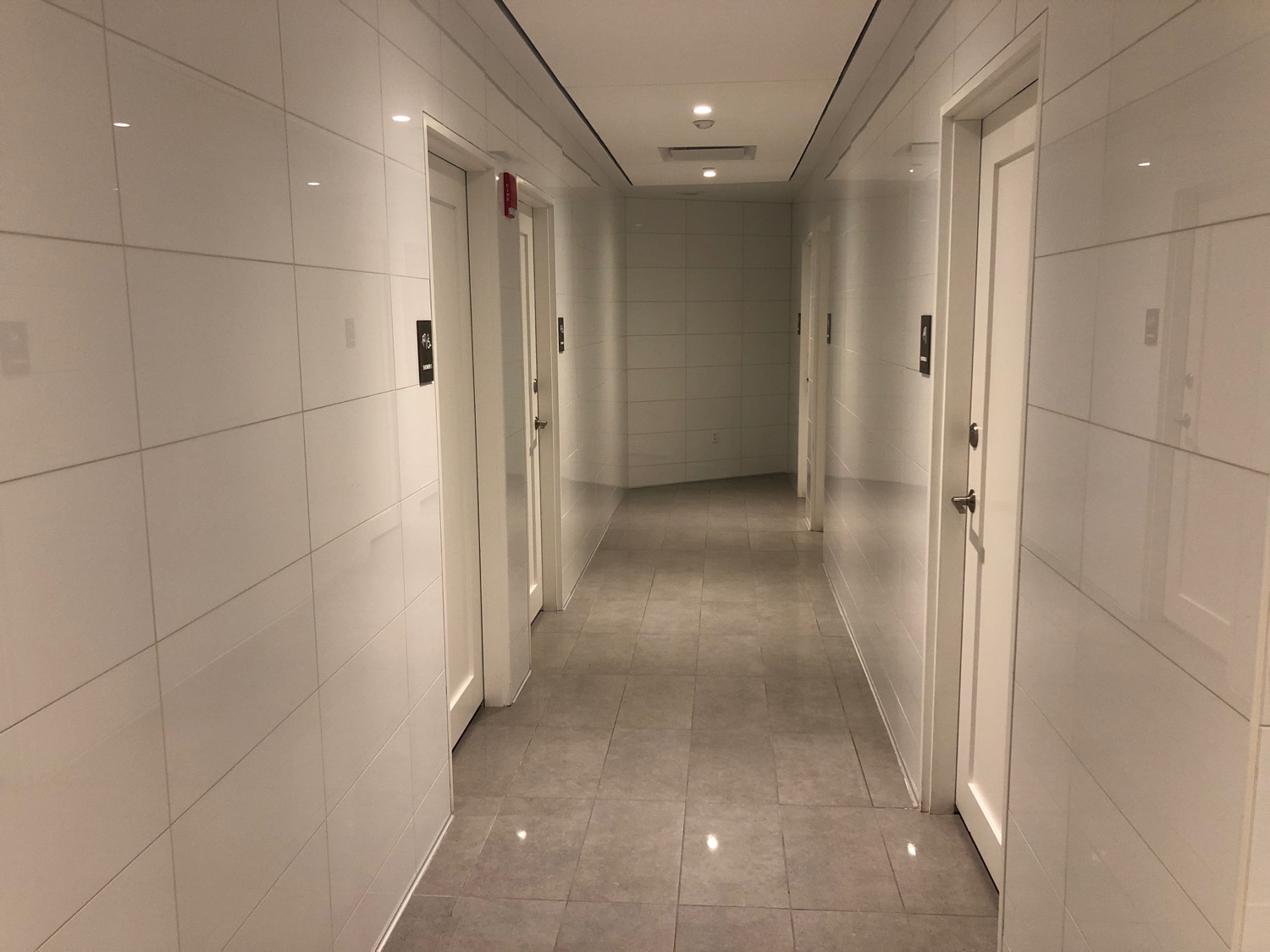 a hallway with white walls and doors