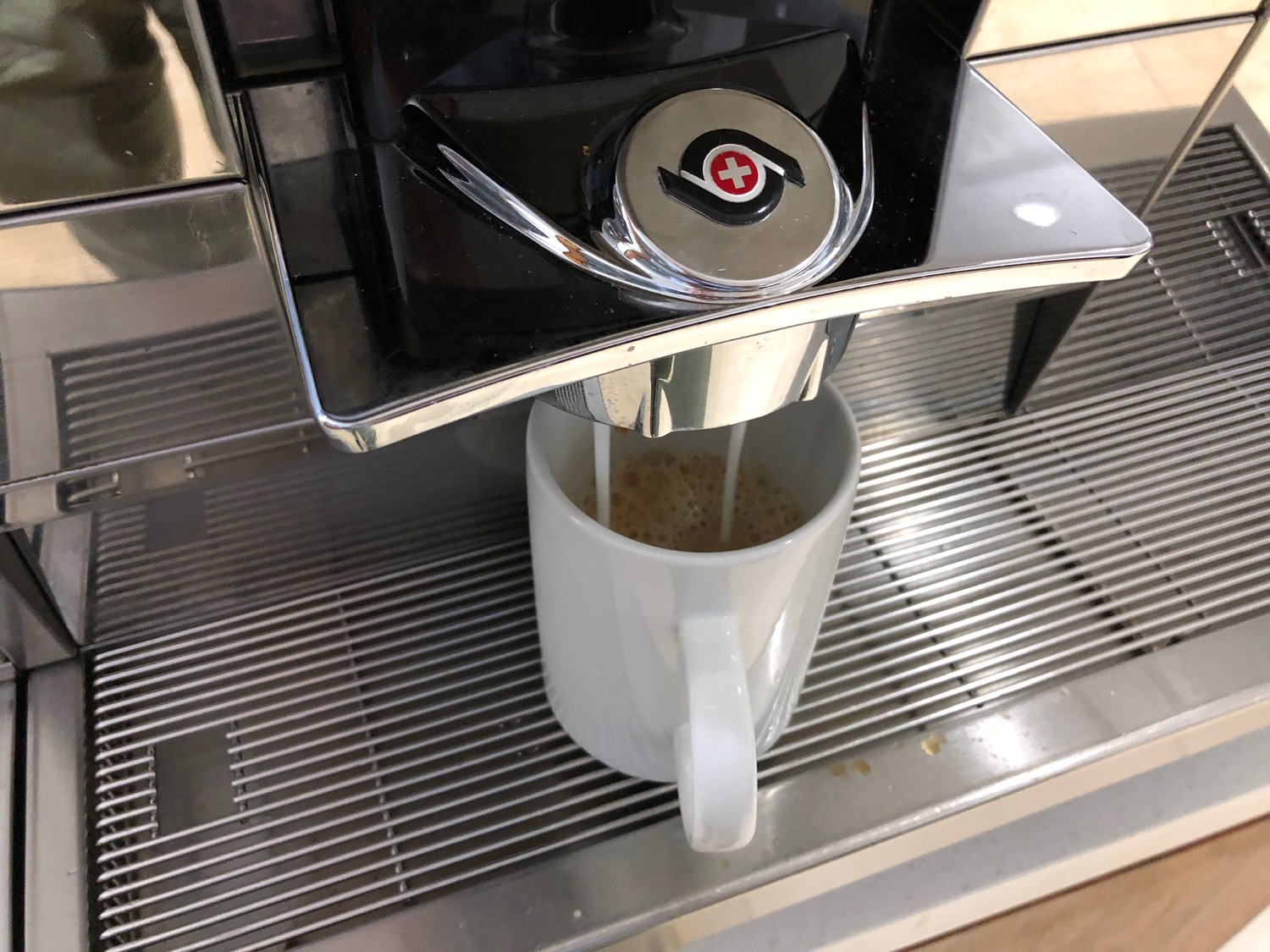 a coffee machine making a cup of milk